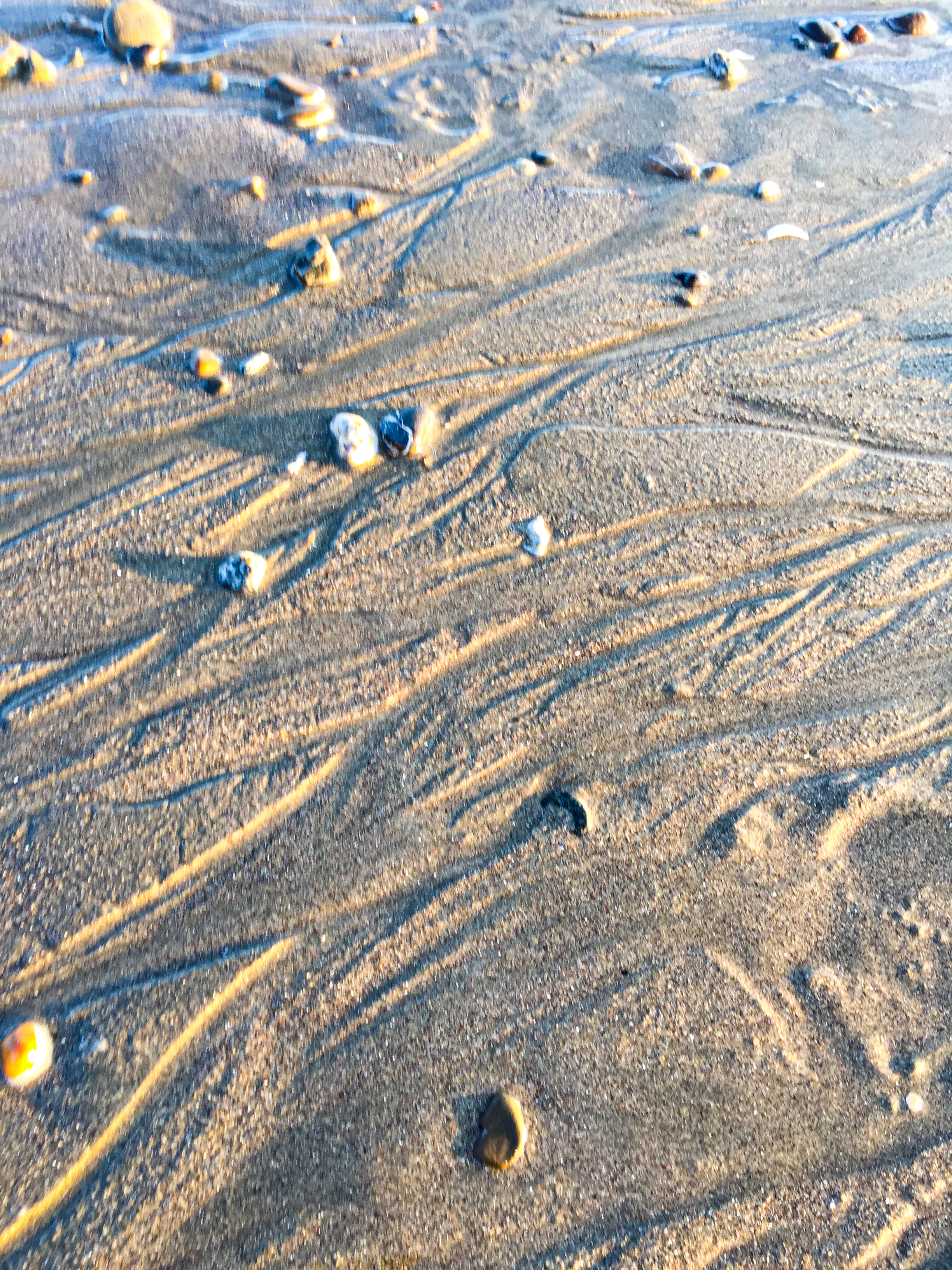 water carving channels on the shore