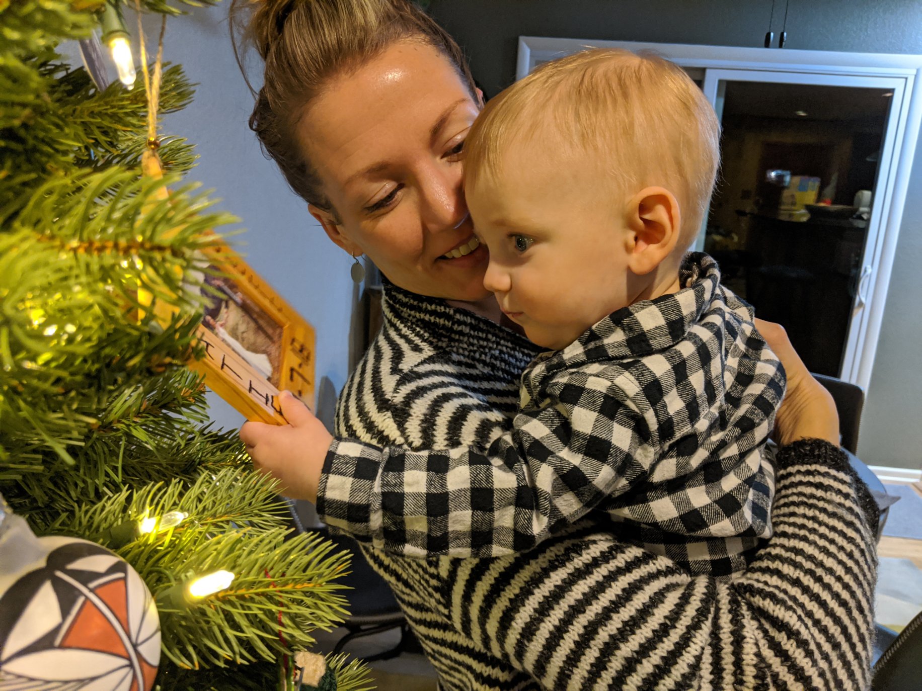 Owen and Katie stand at the Christmas tree