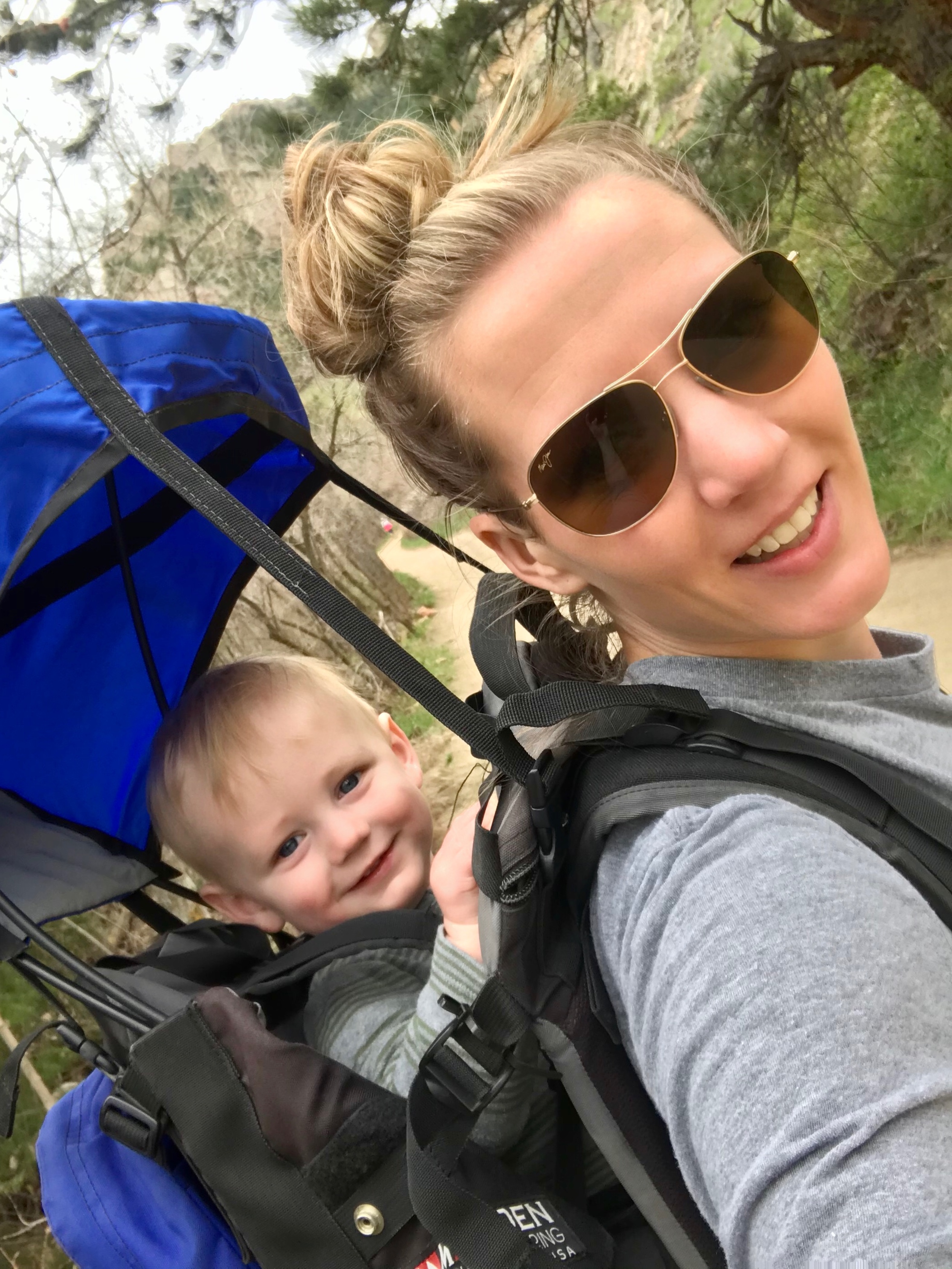 Katie hiking with Owen in the backpack.