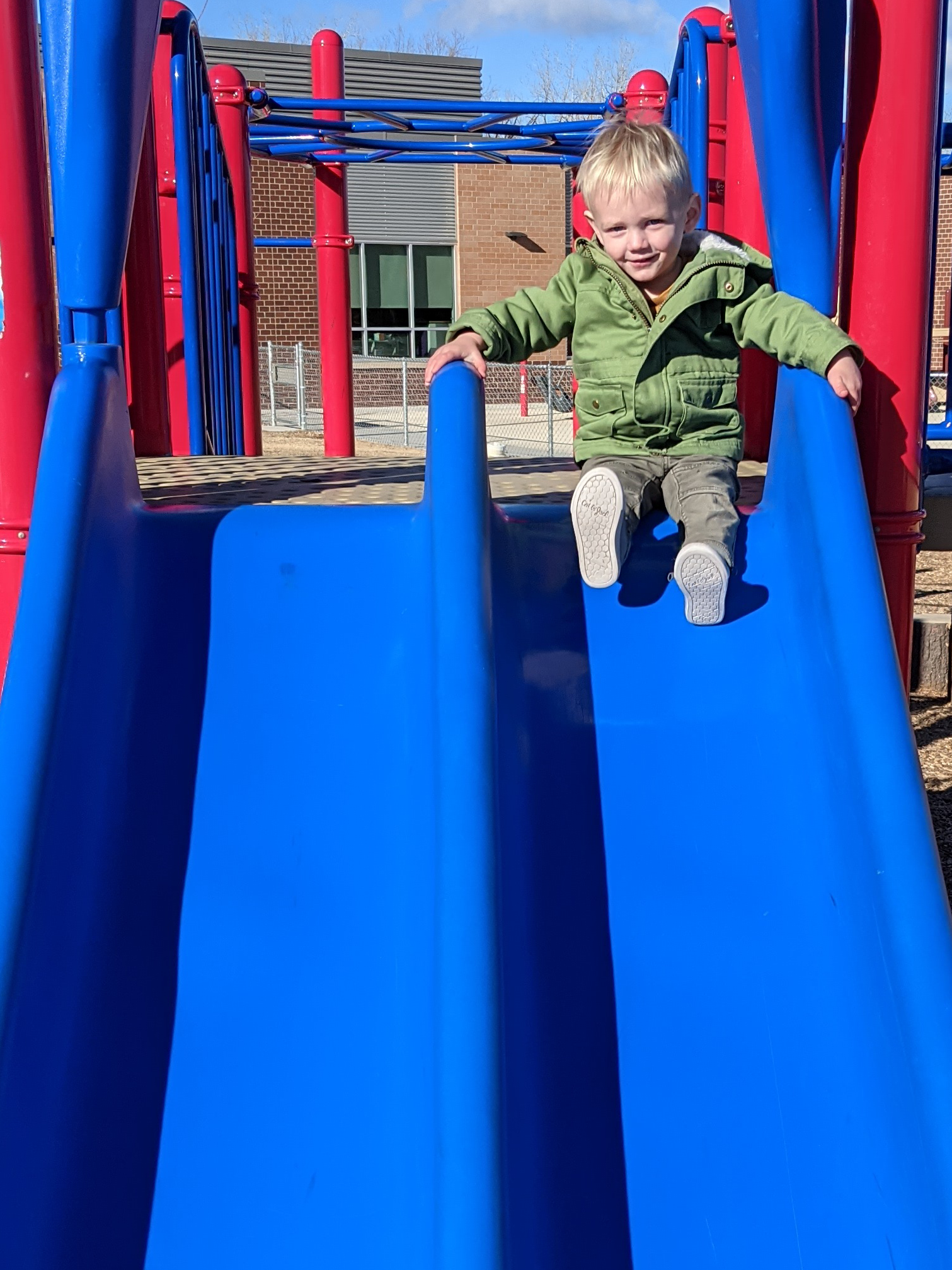 Owen perched at the top of a slide.