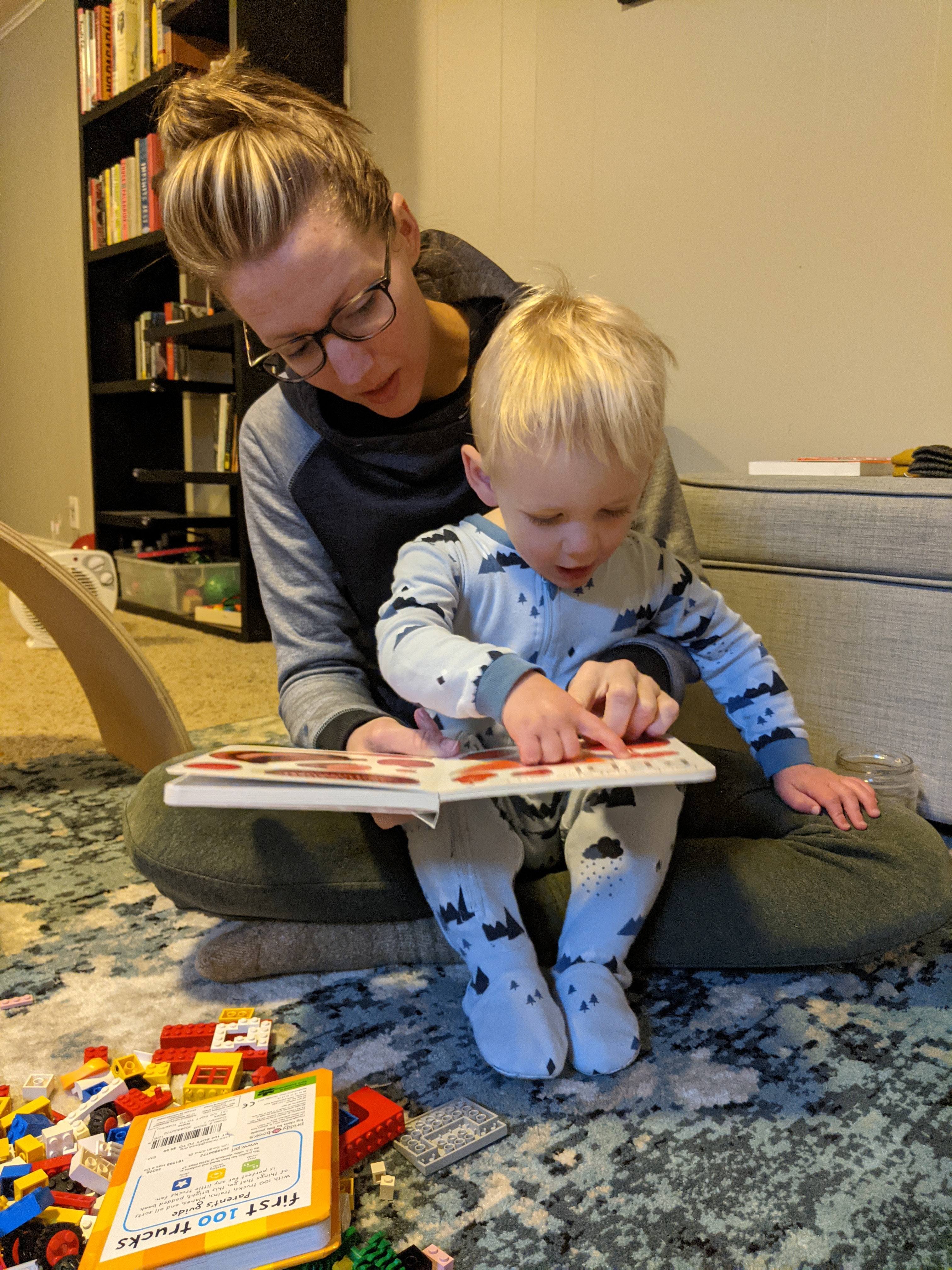 Owen sitting in Katie's lap reading a new book.