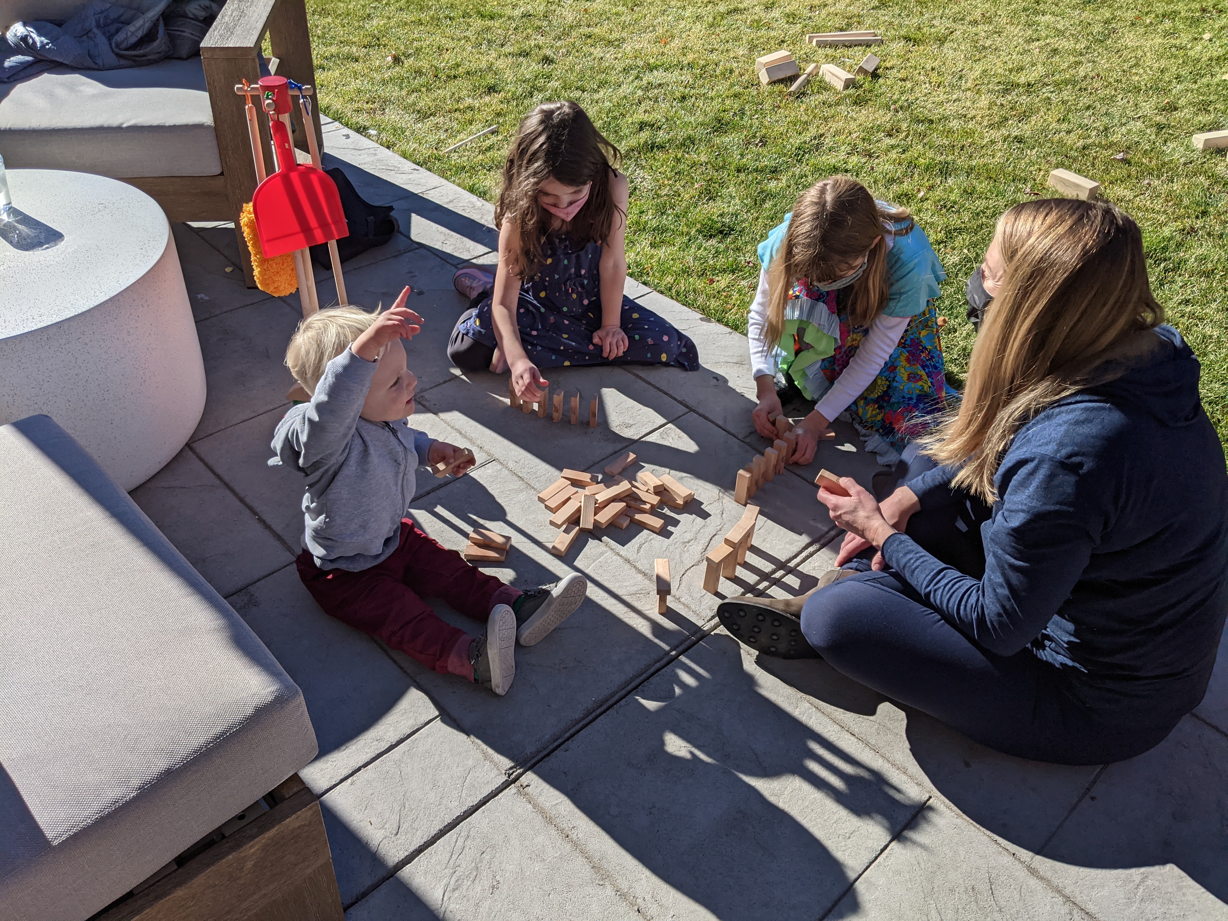 Owen, Elliot, Ainsley, and Alison playing with blocks on the back patio on Thanksgiving.