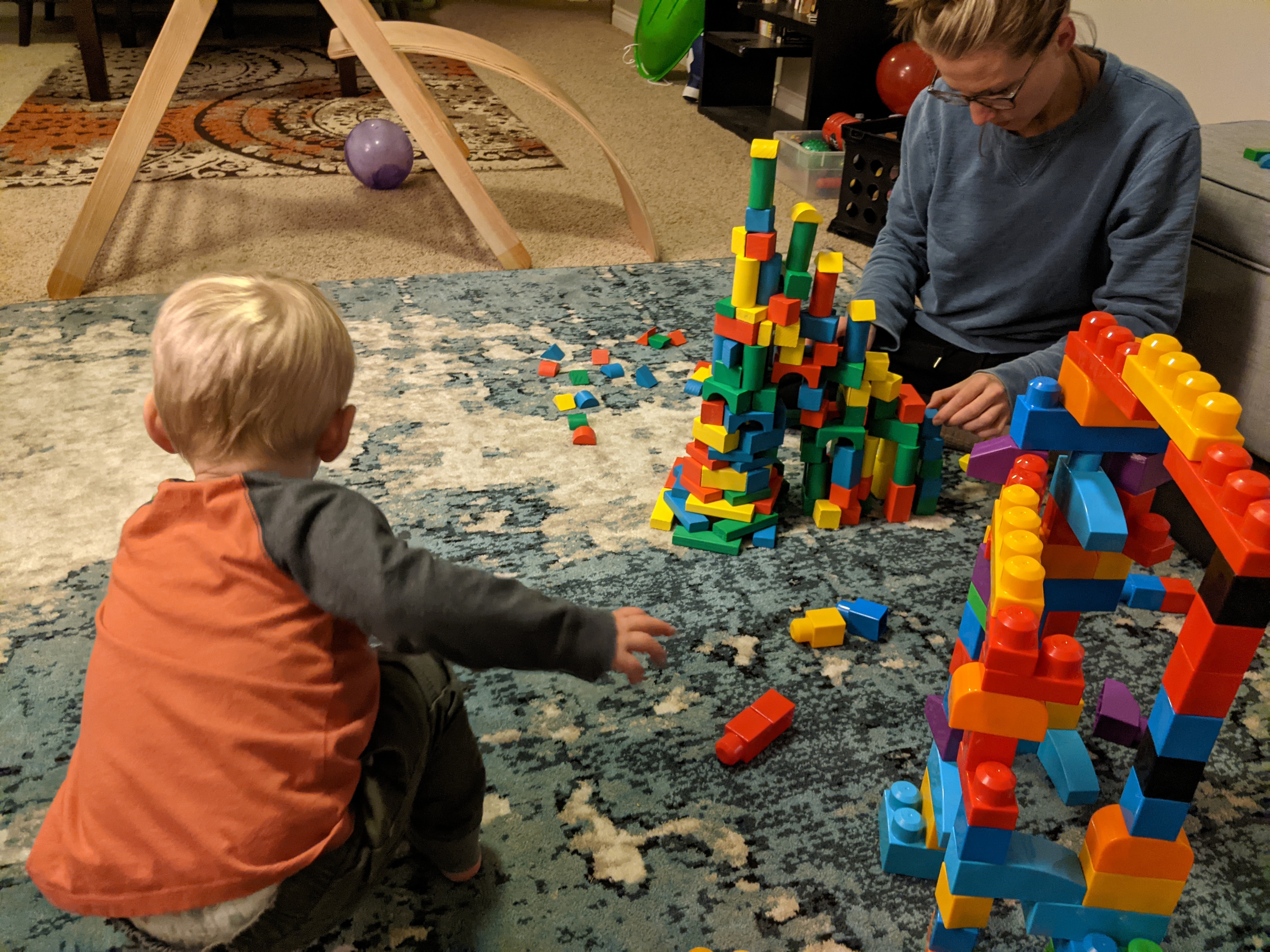Owen and Katie building towers with blocks.