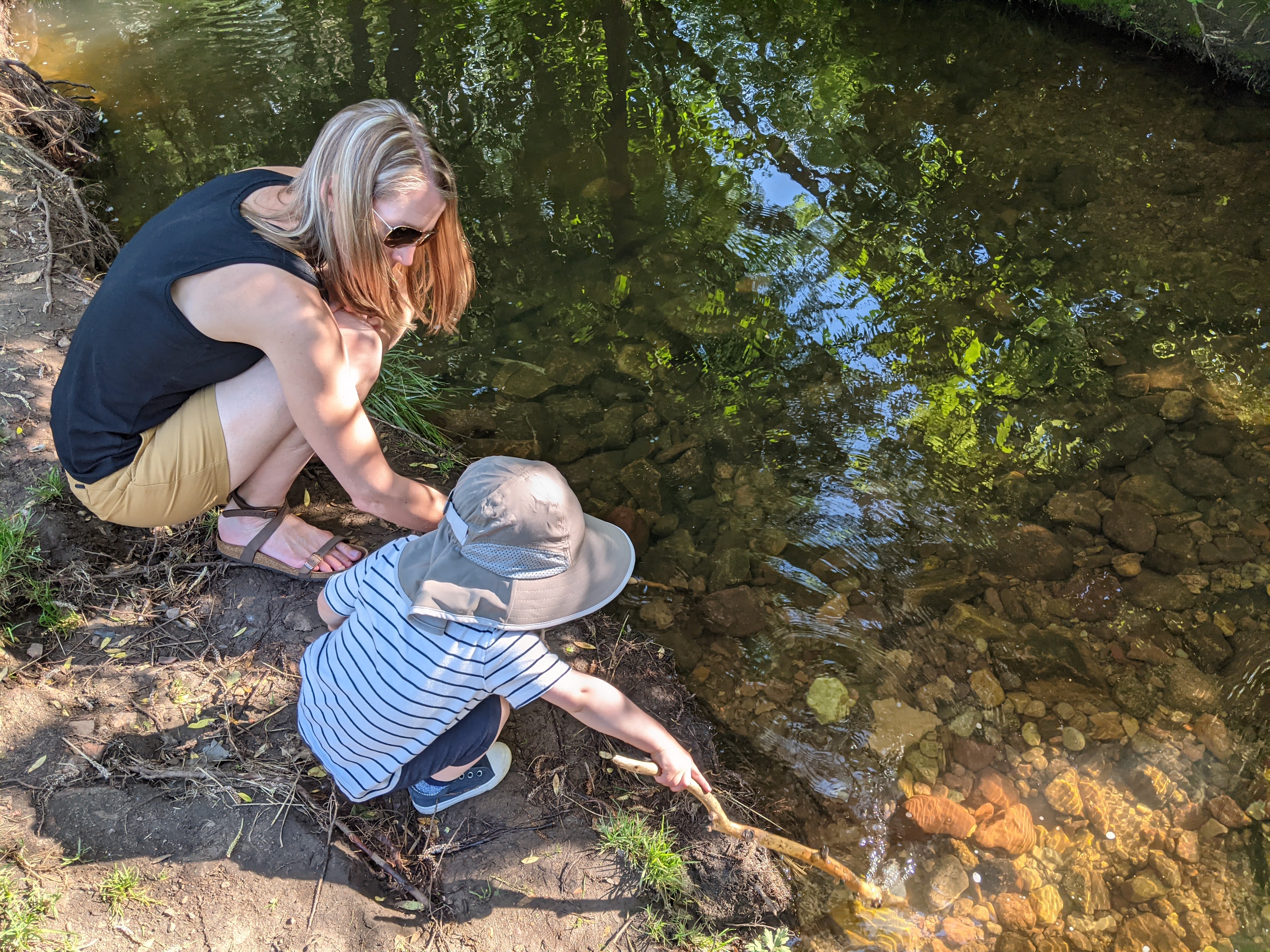 Owen with his mom by the creek